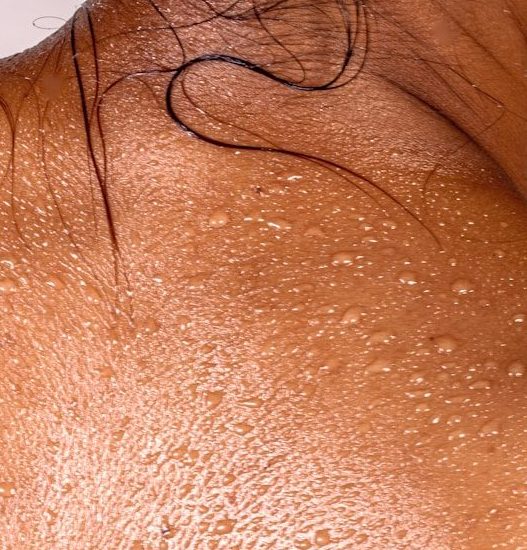 the back of a woman's head with white spots on it