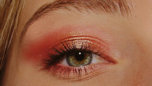 woman with pink and gold eyeshadow makeup