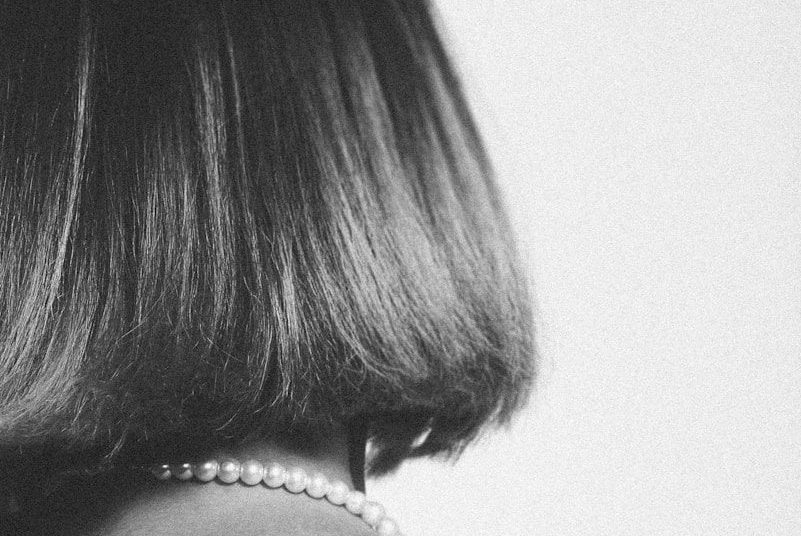 A black and white photo of a woman with short hair