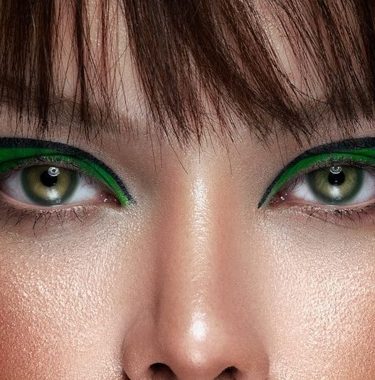 a close up of a woman with green eyes