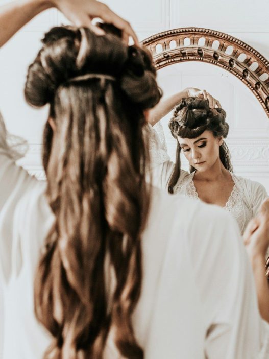 woman wearing white dress standing in front of mirror